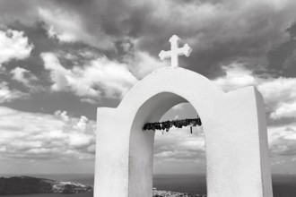 Love locks on the bell tower of an orthodox church, monochrome, hiking trail from Fira to Oia,