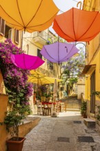 Coloured umbrellas span the Via Cavour, Capoliveri, Elba Island, Tuscan Archipelago National Park,
