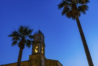 Illuminated steeple of the Madonna del Carmine church, night shot, Porto Azzurro, Elba Island,