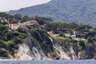 Holiday homes above rocky cliffs, Portoferraio, Elba Island, Tuscan Archipelago National Park,