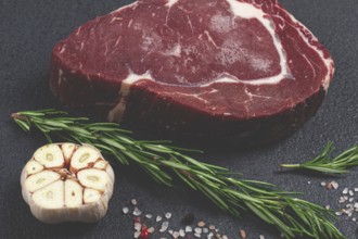 Raw steak, beef steak, rib eye steak, on the table, top view, no people, on a dark background
