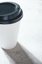 Coffee cup on the table, minimalistic design, disposable tableware, daylight