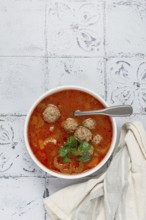 Romanian soup with meatballs, vegetable soup with meatballs, tiled table, homemade, no people