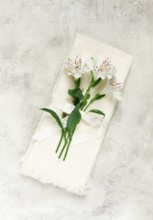 Kitchen towels, cream color, with alstroemeria, Peruvian lily, top view, concept, decor, no people