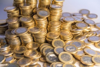 Lots of stacked 1 euro coins