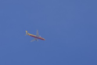Boeing 767 jet aircraft of DHL cargo airlines in flight in a blue sky, England, United Kingdom