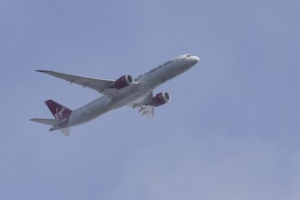 Boeing 787-9 Dreamliner jet passenger aircraft of Virgin Atlantic airlines in flight in a blue sky,