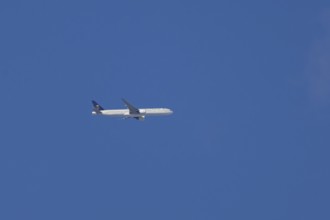 Boeing 777 jet passenger aircraft of Saudi airlines in flight in a blue sky, England, United