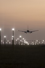 Boeing 737 jet aircraft of Ryanair airlines in flight landing at sunset at London Stansted airport,