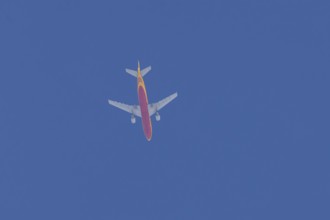 Boeing 767 jet aircraft of DHL cargo airlines in flight in a blue sky, England, United Kingdom