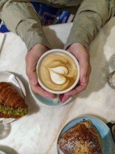 Cappuccino with heart-shaped latte and croissants served on a breakfast table Lower Austria Austria