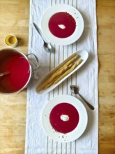 Beetroot soup with cream on a laid table with grissini and candle Lower Austria Austria