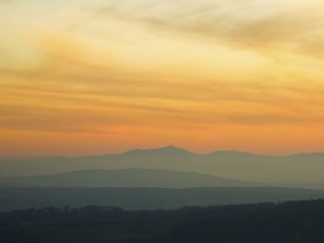 Silhouettes of mountains in the soft light of a pastel-coloured sunset Leiserbergen Weinviertel