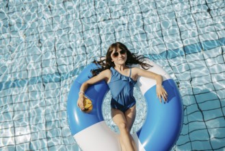 Girl, 10, swims in a swimming tyre in the pool