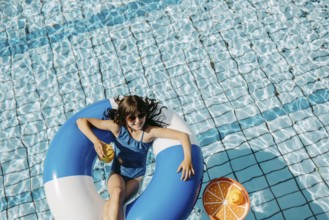 Girl, 10, swims in a swimming tyre in the pool