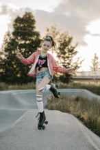 Girl with roller skates on a skating rink