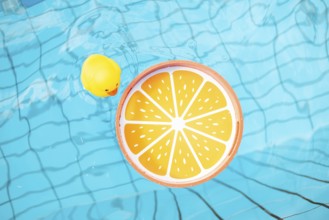 Orange tray and yellow rubber duck in the pool