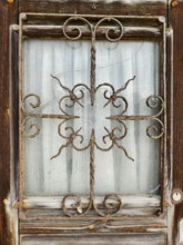 Old, rusty window grille in a weathered wooden frame Lower Austria Austria