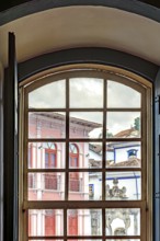 View of the city of Ouro Preto through an old window in a colonial mansion, Ouro Preto, Minas