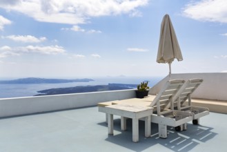 Two deckchairs on a sun terrace with sea view, Imerovigli, Thira, Santorini, Cyclades, Greece