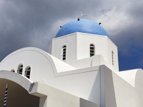 Orthodox church with blue dome, dramatic cloudy sky, Firostefani, Thira, Santorini, Cyclades,