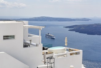 Characteristic white holiday homes with views of the caldera and the Aegean Sea, cruise ship,