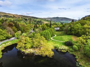 Farms and Mountains over road A591 from a drone, Grasmere Lake, Grasmere, Ambleside, Lake District,