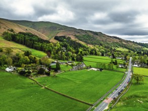 Farms and Mountains over road A591 from a drone, Grasmere Lake, Grasmere, Ambleside, Lake District,