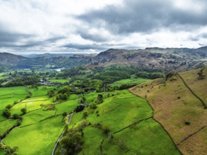 Farms and Mountains over road A591 from a drone, Grasmere Lake, Grasmere, Ambleside, Lake District,