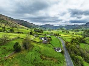 Farms and Mountains over road A591 from a drone, Grasmere Lake, Grasmere, Ambleside, Lake District,
