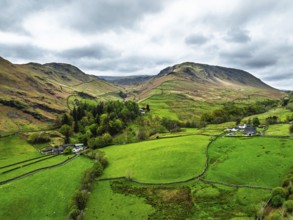 Farms and Mountains over road A591 from a drone, Grasmere Lake, Grasmere, Ambleside, Lake District,