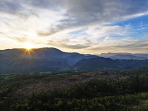 Sunset over Mountains and Coniston Water from drone, Lake District National Park, Cumbria, England,