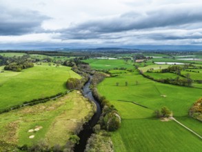 Farms and mountains over Ullswater Lake from drone, Pooley Bridge, Lake District National Park,