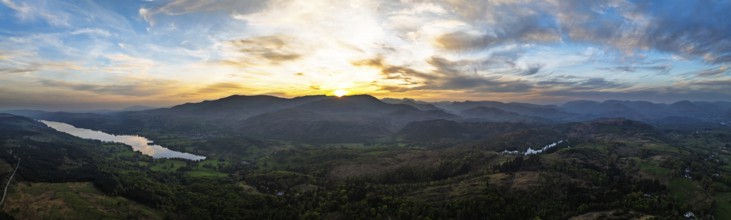 Panorama of Sunset over Mountains and Coniston Water from drone, Lake District National Park,