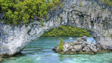 View through rock arch Natural Arch in lagoon of in island paradise island state Palau in the
