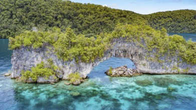 Aerial view bird's eye view through rock arch Natural Arch in lagoon of island paradise island