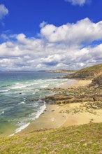 Rolling waves to the beach at a rocky coastline a beautiful sunny day by the sea, Crozon peninsula,