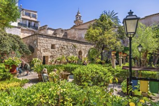 People visit The Arab baths in the old town in Palma de Mallorca an old botanical garden with lush