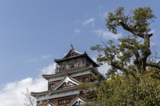 Hiroshima Castle, also known as Carp Castle, against a blue sky, replica of the original destroyed