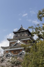 Hiroshima Castle, also known as Carp Castle, against a blue sky, replica of the original destroyed