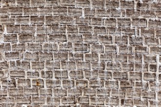 General view of a textured brick wall in earthy tones with an antique look, A wall made of salt