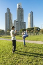 Two young men performing a martial arts drill outdoors