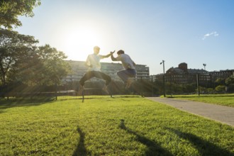 Synchronized martial arts jumps in a sunny park