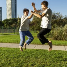 Two young men performing aerial Taekwondo kicks
