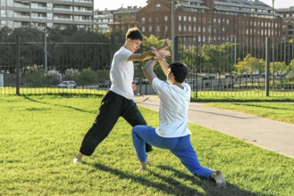 Young martial artists practicing a grappling hold outdoors