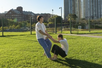 Two young men laughing while practicing a Jiu Jitsu drill