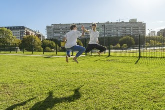 Two young men performing aerial Taekwondo kicks with copy space