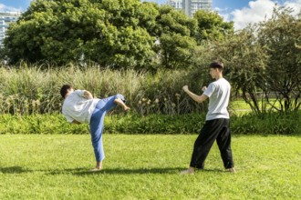 Young athletes mastering Jiu Jitsu outdoors