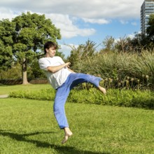 Young man demonstrating agility in a park