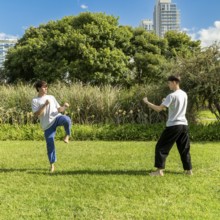 Focused martial arts practice in a green setting